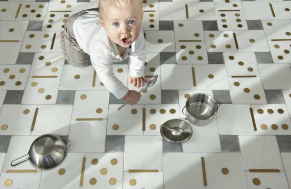 Dominotion, a waterjet mosaic shown in polished Allure, Dolomite, and Brass, is part of Cean Irminger's third Kiddo collection, Kiddo: Heyday™ for New Ravenna.